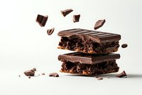 Dark chocolate bars stacked with crispy layers and scattered pieces against white background, showing rich texture and decadent filling for food photography.