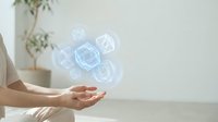 Female hands presenting holographic geometric shapes floating above palm in modern minimalist interior with natural lighting for technology presentations.