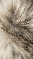 Close-up macro shot of soft fluffy fur texture in beige and gray tones, showing fine hair details for fashion, textile, or nature backgrounds.