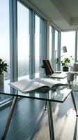 Modern office workspace with glass desk and floor-to-ceiling windows overlooking city skyline. Natural light illuminates contemporary business interior with plants.