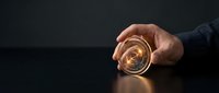 Businessman holding glowing compass with golden light against dark background, symbolizing direction, navigation, and business strategy for corporate concepts.