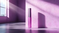 Pink lip gloss container on pink surface with dramatic window light and shadows creating minimal cosmetic product composition for beauty marketing.