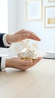 Businessman hands protecting wooden house model with percentage symbols representing mortgage rates and real estate investment protection concept.