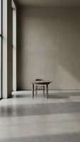 Minimalist interior with wooden desk and chair in empty concrete room with natural light from window, suitable for modern office and design projects.