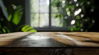 Rustic wooden table surface with natural grain texture and soft window light creating atmospheric mood, green plants in background for product display.