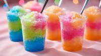 Colorful layered slushie drinks with vibrant blue, green, pink and orange frozen beverages in clear cups with straws, perfect for summer refreshment, parties and beverage marketing.