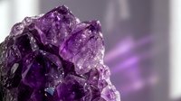 Raw amethyst crystal cluster with deep purple gemstone formations and natural mineral texture for healing and spiritual practices.