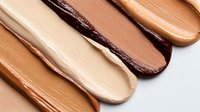 Foundation makeup swatches in various skin tones from light to dark brown displayed on white background for cosmetic color matching and beauty products.