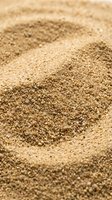 Close-up of fine sand texture with shallow depth of field, suitable for backgrounds, nature concepts, and beach-related design projects.