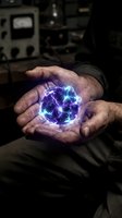 Scientist or technician with weathered hands holding glowing plasma energy sphere in laboratory setting with electronic equipment in background.