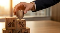Professional businessman hand placing protective shield over wooden blocks with financial symbols including growth chart and percentage sign representing business security and risk management.