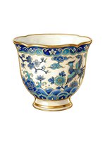 Porcelain teacup with blue and gold decorative patterns featuring floral motifs, birds, and scrollwork on cream background. Ideal for tableware, home decor, and design projects.