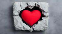 Red heart shape breaking through concrete wall, dramatic lighting effect on gray stone background, symbolizing breakthrough, strength and love.
