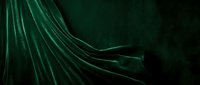 Flowing emerald fabric with dramatic folds and pleats against dark background, suitable for luxury fashion, textile design, and elegant backdrop projects.