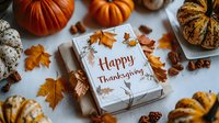 Festive gift box with Happy Thanksgiving text surrounded by orange autumn leaves, pumpkins, and seasonal decorations on white textured background for holiday celebration.
