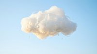 Single fluffy white cloud floating in clear blue sky perfect for weather concepts and nature backgrounds.