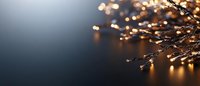 Glowing fairy lights creating magical bokeh effect against dark background, warm golden illumination with copy space for seasonal designs.
