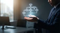 Asian businessman in suit holding glowing digital flowchart hologram, symbolizing workflow automation and business process management.