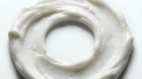Whipped cream swirl isolated on white background, overhead view showing texture and peaks for food photography, culinary design, and bakery marketing materials.