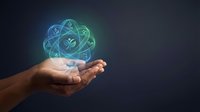 Hands holding glowing atomic structure with plant symbol representing sustainable energy, green technology and environmental science innovation on dark background.