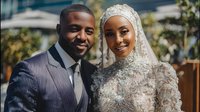 Happy African American Muslim couple in traditional wedding attire smiling together outdoors on their special day celebrating love and marriage ceremony.