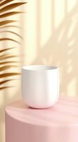 White ceramic pot on pink pedestal with palm leaf shadow on beige wall background. Minimal modern composition for product display or home decor styling.