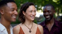 Diverse group of young friends laughing together outdoors in natural lighting, showing genuine joy and connection during casual summer gathering.