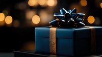 Navy blue gift box with metallic bow against dark background with golden bokeh lights creating festive holiday atmosphere. Perfect for celebration designs.