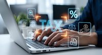 Professional businessman typing on laptop with digital tax icons and financial symbols floating above keyboard in modern office environment.