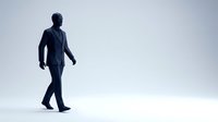 Professional businessman in dark suit walking confidently against minimalist white background for corporate presentations and business concepts.