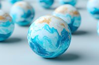 Marbled spheres in turquoise and white colors arranged on light surface. Abstract decorative balls with swirling patterns create elegant composition.