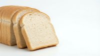 Fresh sliced white bread loaf on clean background perfect for food packaging design and culinary projects.
