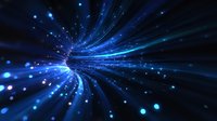 Glowing blue light rays bursting from center point with floating particles and bokeh effects creating dynamic motion and energy in dark space background.