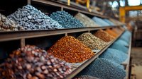 Colorful spices and seasonings displayed on traditional market shelves, including peppercorns, chili flakes and aromatic seeds in vibrant hues of red, blue and brown.