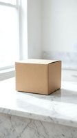 Brown cardboard delivery box on marble surface near window with natural light for shipping and packaging concepts.