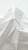 Crumpled white and beige linen fabric with layered folds and soft shadows, isolated on neutral background for textile design and fashion projects.