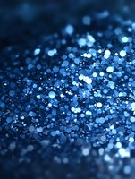 Magical blue glitter bokeh effect on dark background creates dreamy atmosphere with scattered light particles and blurred sparkles. Suitable for festive designs.