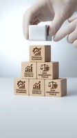 Hand in gloves placing wooden block on pyramid of cubes with financial planning, growth metrics and risk assessment icons for business strategy concepts.