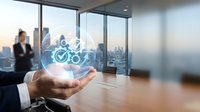Businessman holding holographic eco-friendly transportation icons with bicycle and checkmark in modern office overlooking city skyline at sunset.