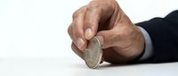Businessman hands holding silver coin on white background isolated for financial investment and savings concept.