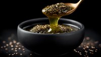 Golden honey dripping from wooden spoon with chia seeds into black ceramic bowl on dark background, macro food photography with selective focus.
