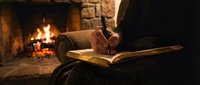Person writing in open book by fireplace with warm glowing flames in background, cozy reading and journaling scene for creative writing, literature, and relaxation content.