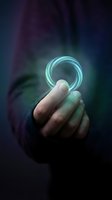 Hand holding glowing cyan neon ring against dark moody background with purple and blue tones. Futuristic technology concept for digital innovation, sci-fi design, and modern creativity projects.