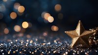 Golden star decoration on glittery dark surface with blurred bokeh lights creating magical festive atmosphere. Holiday season background with warm glow and sparkle.