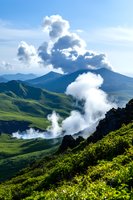 Dramatic mountain landscape with steam rising from volcanic vents amid green slopes and blue peaks, natural geological activity captured in morning light.