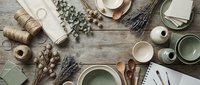 Rustic kitchen flatlay with sage green ceramics, dried lavender, eucalyptus, wooden spoons and natural twine on weathered wood background for cooking.