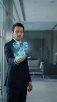 Businessman in dark suit displaying holographic health and wellness icons in modern office environment for healthcare technology concepts.