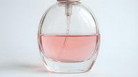 Clear glass perfume bottle filled with pink fragrance liquid, isolated on white background for product photography and cosmetic design use.