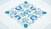 Ornate blue floral mandala with decorative swirls and flourishes on white background, suitable for textile design, wallpaper, and home decor projects.