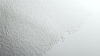 White textured paper with rough torn edge and embossed surface detail for creative design projects and artistic backgrounds.